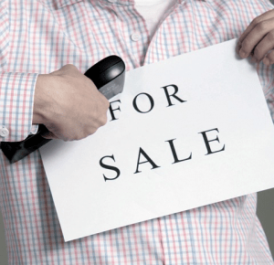 Man holding for sale sign